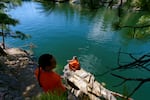 Colville tribal member Shelly Boyd looks over the waters covering the historical fishing grounds of Kettle Falls. The falls, where tribes from the Northwest gathered for thousands of years to fish for salmon, were submerged with the creation of Grand Coulee Dam.