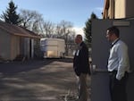 Pendleton Superintendent Jon Peterson (right) and Pendleton High School principal Dan Greenough look over a storage lot next to the high school. It used to be full of student projects. With the wood shop closed, there's little here.