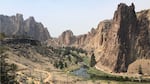 A stunning canyon with a river running through it appears slightly hazy due to wildfire smoke.