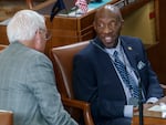 State Sen. Aaron Woods, D-District 13, right, talks with a colleague at the Oregon Capitol in Salem, March 20, 2023. 