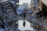 Palestinians walk amid the rubble of destroyed homes and buildings in Jabaliya, northern Gaza Strip, March 14.