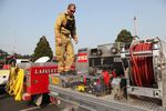 A firefighter makes sure his equipment is in good working order on Aug. 25, 2017 after a long day on the lines fighting the Chetco Bar wildfire near Brookings, Oregon.