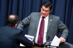 Rep. Austin Scott, R-Ga., right, and Rep. Jason Crow, D-Colo., talk during a break in the House Armed Services Committee hearing in 2021. On Friday Scott announced his candidacy for House speaker.