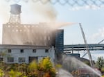 Firefighters and other emergency personnel monitor and battle a fire in downtown Portland, Ore., on Aug. 2, 2026. The fire was at an abandoned building on northwest Naito Parkway.