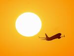 An airplane flies at sunrise over Buenos Aires, Argentina, on March 9.
