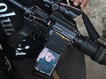 In Jenin refugee camp, a fighter shows a photo on his gun he says is a reminder of another young fighter who was killed by the Israeli army.