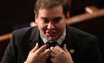 Former New York Republican Rep. George Santos, wearing a glittering collar, attends the State of the Union address Thursday night in Washington, D.C.