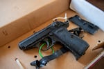 A Walther PPK 4.5mm caliber CO2 air pistol sits in an evidence box, April 19, 2025.