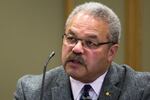 Oregon state Sen. Lew Frederick, a Black man, sits at a microphone.