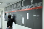A federal officer stands in a hallway at New York Federal Plaza Immigration Court inside the Jacob K. Javitz Federal Building in New York in October 2025.