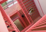 People walk down the winding pink stairs at Portland State University's new Jordan Schnitzer School of Art + Art History + Design on Tuesday, Oct. 13, 2026.