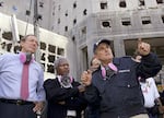 In this Sept. 18, 2001, photo, New York Governor George Pataki stands on the left side of the frame, with U.N. Secretary-General Kofi Annan in the center and New York City Mayor Rudy Giuliani on the right. They are at the World Trade Center attack site in New York City, and a heavily damaged building with missing windows rises in the background.