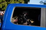 A Border Patrol agent in the back of a vehicle near an Immigration and Customs Enforcement facility in Broadview, Ill., Friday, Oct. 3, 2025.
