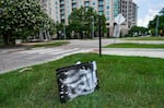 A Flock camera covered in white paint lies in the grass near Washington Avenue and Westcott in Houston on July 7, 2026.