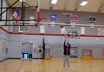 David Douglas High School PE teacher Nathan Tew shoots hoops in a school gym on Jan. 22, 2025. Tew has known some Class of 2025 students for six years. He first met them in middle school when he taught 7th grade social studies.