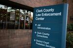 A sign reads "Clark County Law Enforcement Center." Arrows underneath direct people towards jail administration, Clark County Corrections, and district court probation services.