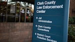 A sign reads "Clark County Law Enforcement Center." Arrows underneath direct people towards jail administration, Clark County Corrections, and district court probation services.