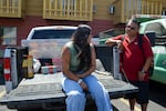 Warm Springs Tribal Members Cajun Scott, left, and Flint Scott at sit on the bed of a truck at a Madras, Ore., motel on July 30, 2026, after evacuating from the Bench Fire.