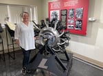 Shannon Massey, senior vice president at Lycoming Engines, next to an antique aircraft engine at the company's Williamsport factory.