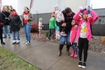 Areli Brambila, center, holds and speaks with her children on the picket line on the first day of Albany's teacher strike on Nov. 12, 2024.