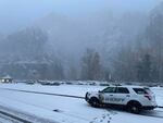 Snowfall in the Columbia River Gorge prompted a warning Friday morning from the Multnomah County Sheriff's Office to use caution traveling on I-84. A sheriff's deputy vehicle can be seen Dec. 1, 2023, near Multnomah Falls.