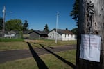 A sign warns of the elevated pH contamination of water in a ditch, posted in a neighborhood across the street from the Nippon Dynawave Packaging Co. after the chemical disaster in Longview, Wash., on May 27, 2026.