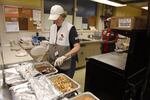 Staff serves food to Chetco Bar Fire evacuees at the Red Cross Relief Center, housed in an elementary school in Gold Beach, Oregon.