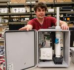 Air Quality Monitoring Specialist Zach Koch displays the SenOR, a new low-cost air quality monitoring device created by the Department of Environmental Quality’s Laboratory for use at designated sites across Oregon.