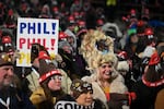 Toni Massey, of Bismack, N.D., right, celebrates while waiting for Punxsutawney Phil, the weather prognosticating groundhog, to come out and make his prediction during the 140th celebration of Groundhog Day on Gobbler's Knob in Punxsutawney, Pa., Monday, Feb. 2, 2026.