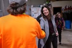 Republican Kelly Ayotte shakes hands with an employee during a visit to a local concrete coating business on Oct. 16 in Manchester, N.H.