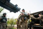 A group of Ukrainian soldiers from the Territorial Defense load a rocket under the cover of trees in the Kherson oblast in October. Ukrainian military units and Western military analysts said at the time the approaching winter might force a change in soldiers' tactics.