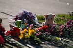 A stuffed animal and other items mark a makeshift memorial in front of Silver Rail Elementary School in Bend, Ore., on Oct. 16, 2026, where an Oct. 15 mass shooting left three children, a teacher and the shooter dead.