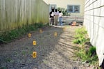 Detectives from the Salem Police Department examine evidence outside Harriet Thompson's home on March 20, 1998. Jesse Johnson was convicted and sentenced to death for Thompson's murder in 2004.