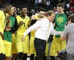 Oregon players celebrate the win over Saint Joseph's with Head Coach Dana Altman (right) after the second round of the NCAA Tournament in Spokane.