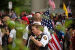 Liaison officers with the Portland Police Bureau monitor a white supremacist rally under the Hawthorne Bridge in Portland, Ore., Saturday, Aug. 17, 2019. The rally carried the potential for violence and attracted hundreds of antifascist counter-protesters.