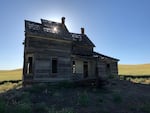 the setting sun peaks through the roof of the Nelson House