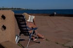 A woman reads while sunbathing during a summer day in Montevideo, Uruguay, Jan. 22, 2025. This January is the hottest ever recorded on Earth.