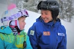 Mackenzie Hunniecutt (in unicorn helmet) gets one-on-one snowboard lessons from OAS instructor Dayna Vogt 