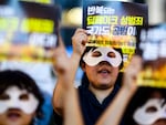 Activists wearing eye masks hold posters reading "Repeated deepfake sex crimes, the state is an accomplice too," during a protest against sexually abusive deepfakes in Seoul, South Korea, on Aug. 30.