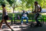 Jesse Johnson, sporting a new hat, relaxes on a park bench and tries out his new cell phone in Portland, Ore., Sept. 8, 2023, days after his release from Marion County Jail in Oregon. Johnson spent 25 years in prison and police custody for the 1998 murder of Harriet Thompson, a murder he consistently denied committing.