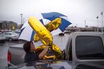 Jamie Yutzie unloads balloons from her car. Yutzie's grandfather, Bill Lapschies, survived the coronavirus to celebrate his 104th birthday. 