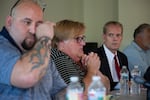 Sue Zawacky, center, talks while son Josh Shorthill, left, wipes tears and attorney Mark Lindquist looks on during a June news conference. The family announced June 24 they intend to sue Clark County over Jenoah Donald's death.