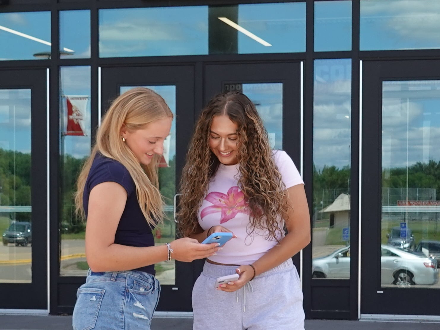 Olivia Kanavati, left, and Evangeline Fuentes, right, are members of the Digital Well-Being Club at their school and say they support a new state law that will require social media companies to add mental health warning labels to their sites starting next year. The pair posed for photos outside their school on July 17, 2025.