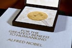 FILE - A Nobel diploma and medal are displayed, Dec. 8, 2020, during a ceremony in New York.