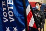 Thomas Hedrich sets up voting flags at a polling location in Gwinnett County, Ga., outside of Atlanta on Monday, Jan. 4, 2021, in advance of the Senate runoff election.