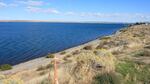 The Columbia River Intertribal Fish Commission says the white dots in the water are tribal fishing buoys and the wooden stake marks the beginning of the proposed Morrow Pacific coal export project site at the Port of Morrow in Boardman.