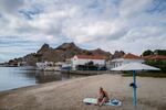 Lemnos, GREECE: 09/29/25 A woman relaxes on the beach in Lemnos, in the northern Aegean. The Greek island is home to roughly 16-thousand people spread across a few dozen small villages. The island is one of many in Greece that’s facing a demographic crisis as a decreasing birthrate has led to school closures Ayman Oghanna for NPR