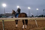 A jockey trains before sunrise on a horseracing track in Louisville, Ky., on April 30, 2025.