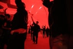 Pilgrims hold a large piece of fabric above their heads while taking part in mourning rituals inside the Imam Hussein Shrine in Karbala during the Arbaeen commemoration.