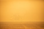 A helicopter is grounded in a smoky field near the incident command center for the Santiam Fire near Gates, Ore., Sept. 9, 2020. Fire, wind and road conditions have been so bad they've slowed search and rescue efforts in the canyon.